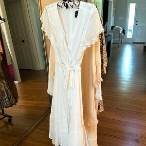 White swissdot dress with flutter sleeves and asymmetrical hemline! 🤍🫖🕊️
